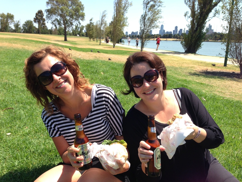 AMY and ALEX on an ANGLE in ALBERT PARK eating AMERICAN BURGERS with ASAHI beer. Clever hey?!